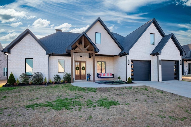 7021 Fields Dr, Alexander, AR 72019 - view of front of property with brick siding, driveway, a garage, a chimney, and french doors