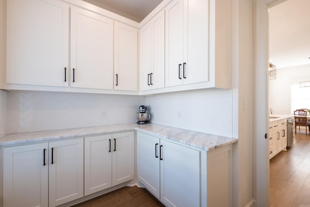 7021 Fields Dr, Alexander, AR 72019 - kitchen with dark wood-style flooring, decorative backsplash, dishwasher, white cabinetry, and light stone counters