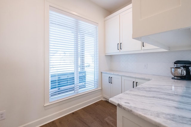 7021 Fields Dr, Alexander, AR 72019 - kitchen featuring dark wood-style floors, decorative backsplash, white cabinets, baseboards, and light stone countertops