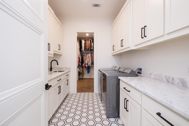 7021 Fields Dr, Alexander, AR 72019 - laundry room with cabinet space, washer and dryer, and light tile patterned flooring