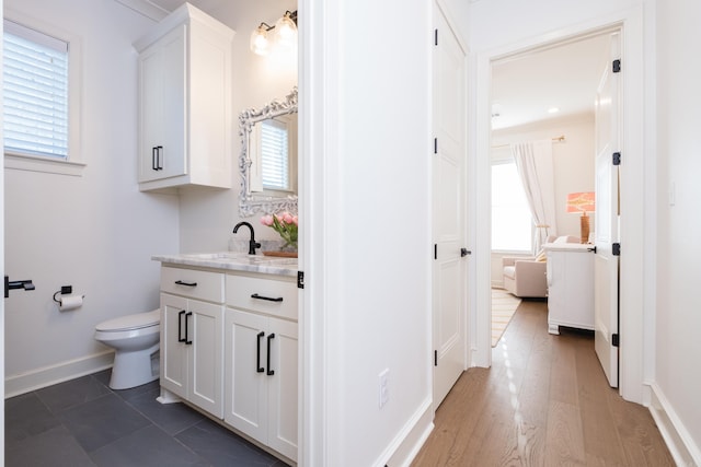7021 Fields Dr, Alexander, AR 72019 - bathroom featuring toilet, vanity, healthy amount of natural light, and baseboards