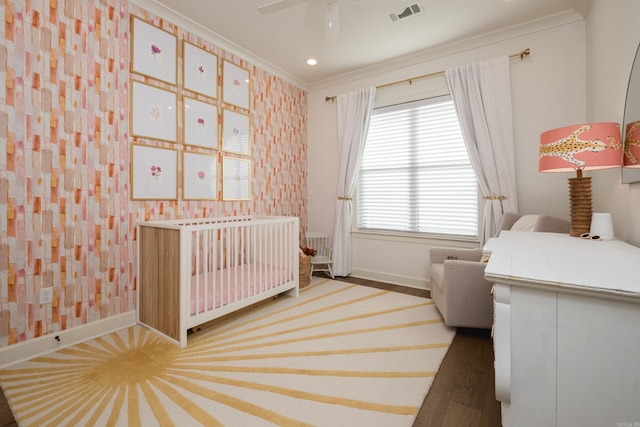 7021 Fields Dr, Alexander, AR 72019 - bedroom featuring crown molding, a crib, baseboards, wood finished floors, and recessed lighting