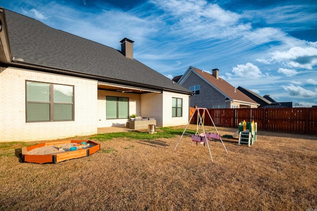 7021 Fields Dr, Alexander, AR 72019 - rear view of property with brick siding, roof with shingles, a chimney, an outdoor living space, and a patio area