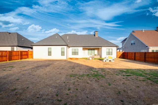 7021 Fields Dr, Alexander, AR 72019 - back of house featuring a fenced backyard, a chimney, and stucco siding