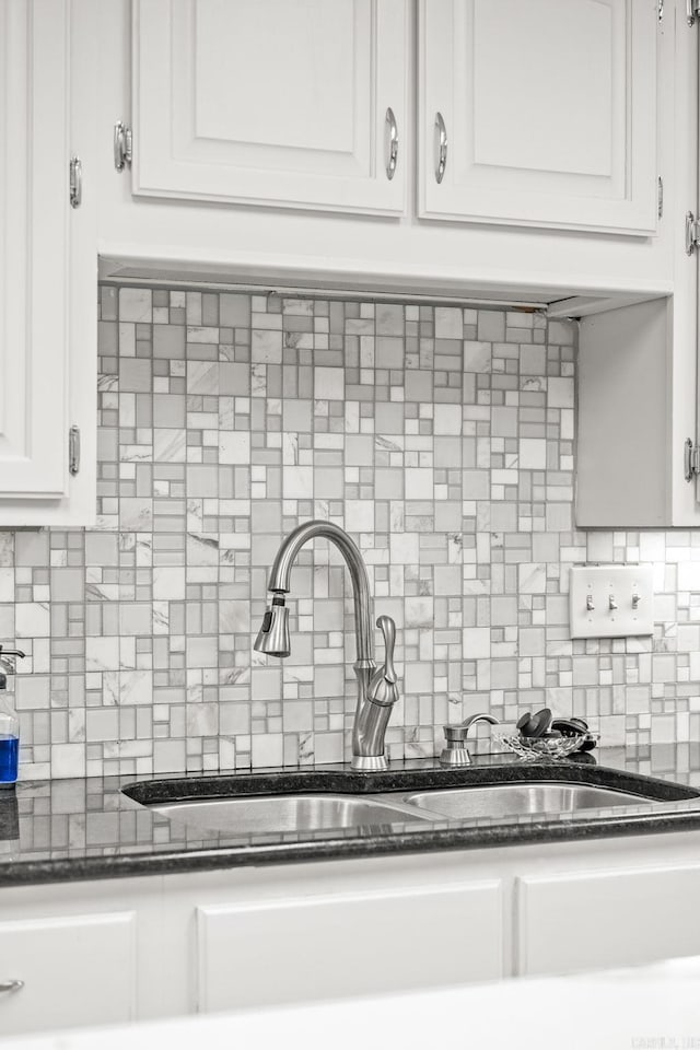 9 Leeward Ct, Maumelle, AR 72113 - kitchen featuring a sink, backsplash, white cabinetry, and dark stone countertops