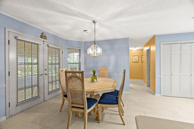 9 Leeward Ct, Maumelle, AR 72113 - dining area with french doors, a textured ceiling, a chandelier, and baseboards