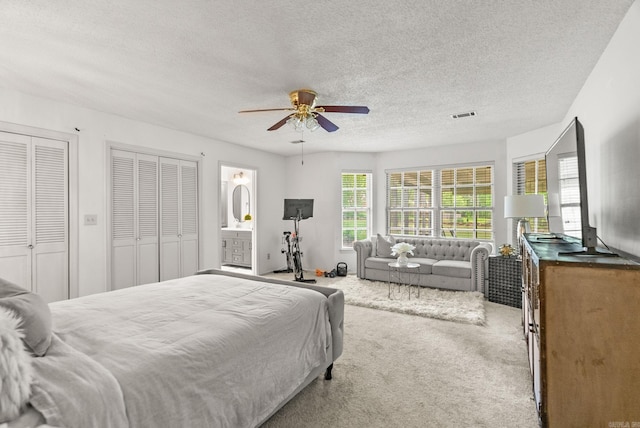 9 Leeward Ct, Maumelle, AR 72113 - bedroom with carpet, a textured ceiling, a ceiling fan, and two closets