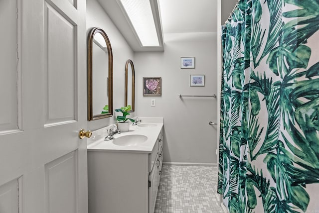 9 Leeward Ct, Maumelle, AR 72113 - bathroom featuring baseboards and double vanity