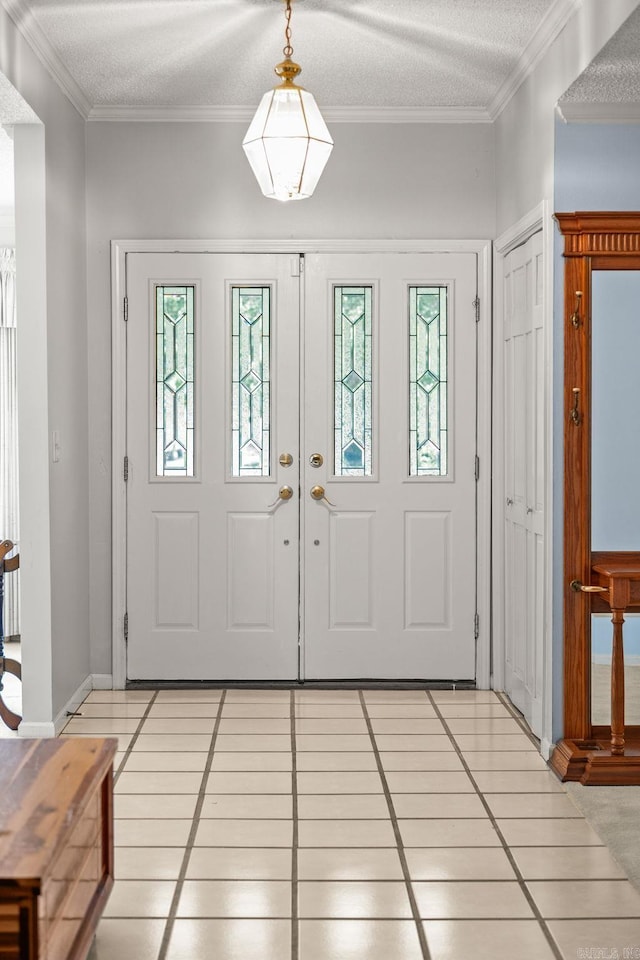 9 Leeward Ct, Maumelle, AR 72113 - foyer featuring light tile patterned flooring, crown molding, baseboards, and a textured ceiling