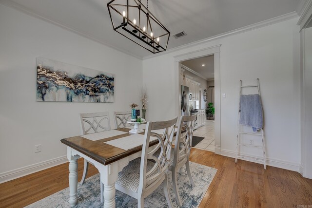 4715 Stockton Rd, Conway, AR 72034 - dining area featuring ornamental molding, a chandelier, light wood finished floors, and baseboards