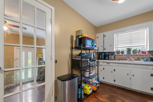 1217 Look St, Little Rock, AR 72204 - kitchen with white cabinets, tasteful backsplash, a sink, and light countertops