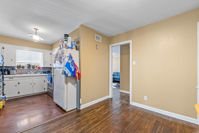 1217 Look St, Little Rock, AR 72204 - kitchen featuring freestanding refrigerator, white cabinets, a sink, electric stove, and baseboards