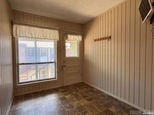 600 Higdon Ferry Rd Unit 203, Hot Springs, AR 71913 - foyer featuring plenty of natural light, a textured ceiling, wooden walls, and dark floors