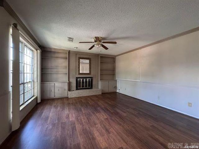 600 Higdon Ferry Rd Unit 203, Hot Springs, AR 71913 - unfurnished living room featuring a textured ceiling, ornamental molding, a ceiling fan, wood finished floors, and built in shelves