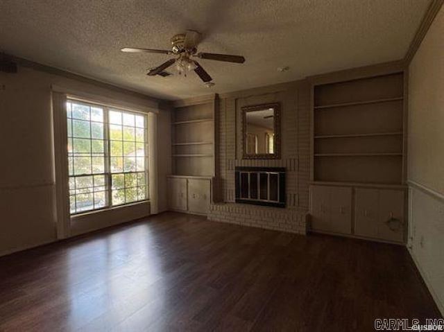 600 Higdon Ferry Rd Unit 203, Hot Springs, AR 71913 - unfurnished living room featuring a textured ceiling, built in features, ceiling fan, wood finished floors, and a brick fireplace