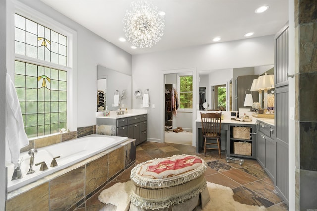 7 Galope Pl, Hot Springs Village, AR 71909 - full bath featuring a garden tub, vanity, recessed lighting, stone tile floors, and a chandelier