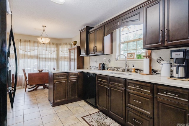 kitchen featuring black appliances, light tile patterned floors, a sink, backsplash, and dark brown cabinets