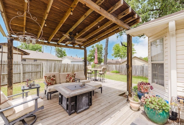 wooden terrace with an outdoor hangout area, a ceiling fan, and outdoor dining space