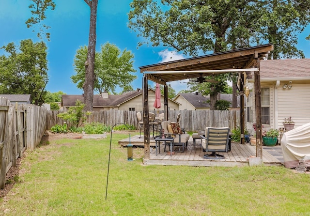 view of yard featuring a deck and ceiling fan