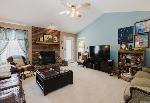 living room with vaulted ceiling, ceiling fan, carpet floors, and a brick fireplace
