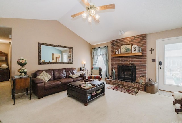 carpeted living room featuring a fireplace, vaulted ceiling, plenty of natural light, and ceiling fan