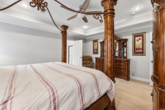 bedroom featuring a tray ceiling, light wood-style flooring, ornamental molding, baseboards, and recessed lighting