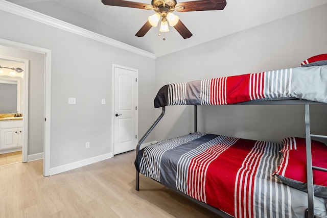 bedroom with light wood-style flooring, ornamental molding, a ceiling fan, a sink, and baseboards