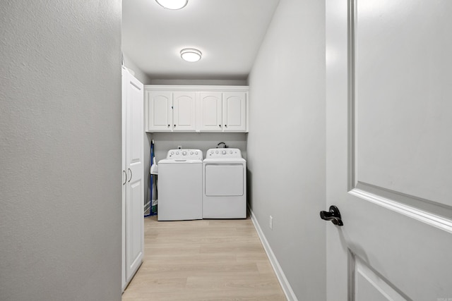 2121 Hickory Dr, Bryant, AR 72022 - washroom with washer and dryer, cabinet space, light wood-style floors, and baseboards
