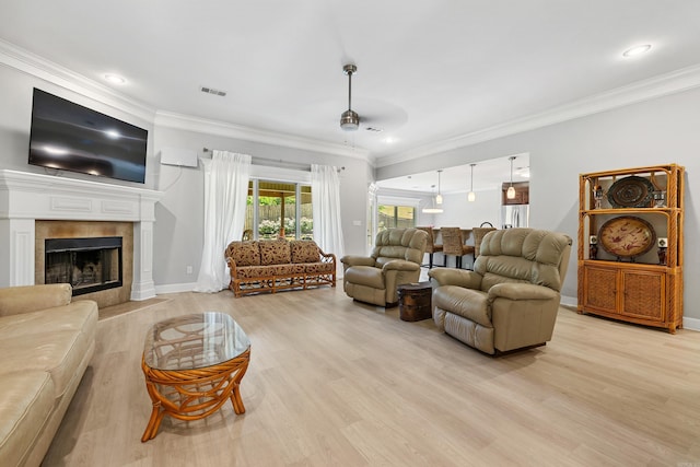 living area with light wood-style floors, crown molding, a fireplace, baseboards, and recessed lighting