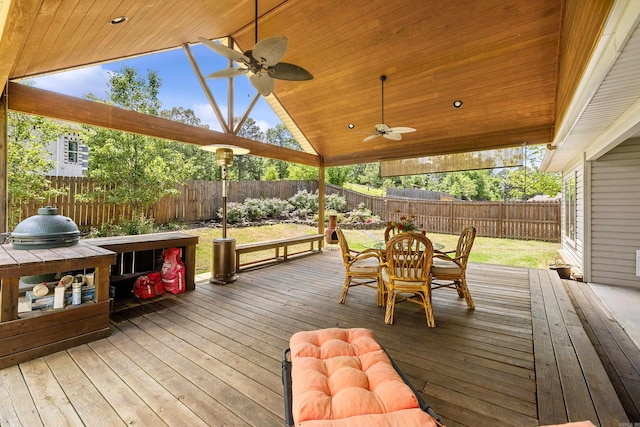 deck with a ceiling fan, a fenced backyard, and outdoor dining space