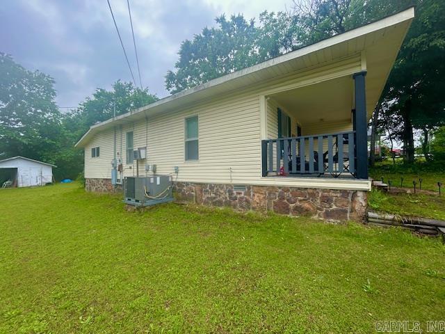 105 W Clinton St, Heber Springs, AR 72543 - view of property exterior featuring cooling unit, a lawn, and crawl space