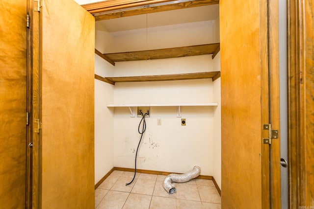 laundry room featuring hookup for an electric dryer, hookup for a washing machine, light tile patterned floors, and baseboards