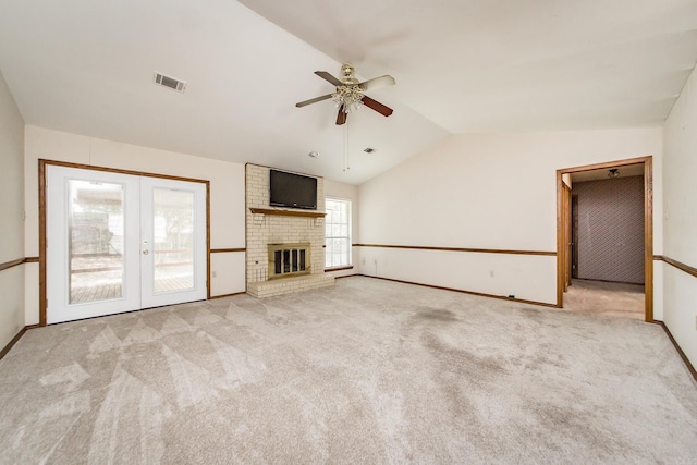 unfurnished living room with lofted ceiling, ceiling fan, carpet, baseboards, and french doors