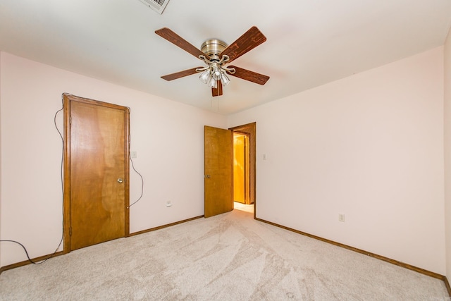 unfurnished bedroom with baseboards, light colored carpet, and a ceiling fan