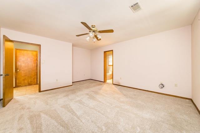 unfurnished room with carpet, a ceiling fan, and baseboards