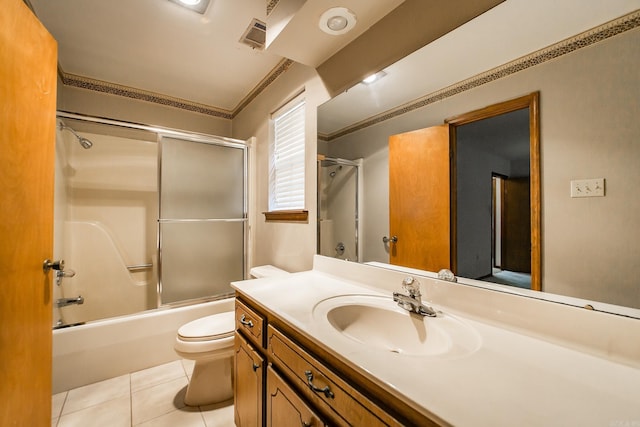 bathroom featuring tile patterned flooring, toilet, vanity, combined bath / shower with glass door, and crown molding