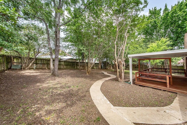 fenced backyard with a deck