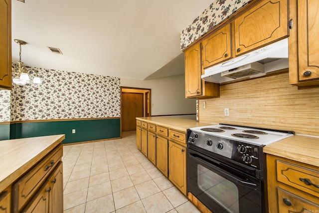 kitchen with black electric range, under cabinet range hood, wallpapered walls, brown cabinets, and light tile patterned floors