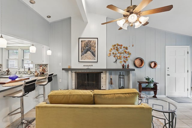 717 Choctaw Cir, Little Rock, AR 72205 - living room with vaulted ceiling, a ceiling fan, and a brick fireplace