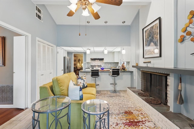 717 Choctaw Cir, Little Rock, AR 72205 - living area with a ceiling fan, wood finished floors, and a brick fireplace