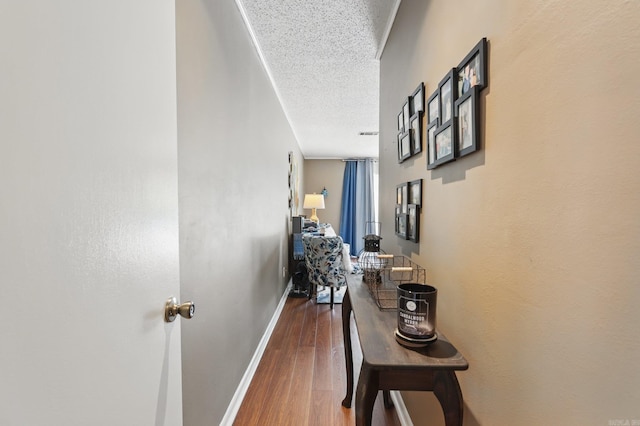 717 Choctaw Cir, Little Rock, AR 72205 - hall featuring a textured ceiling, baseboards, and wood finished floors