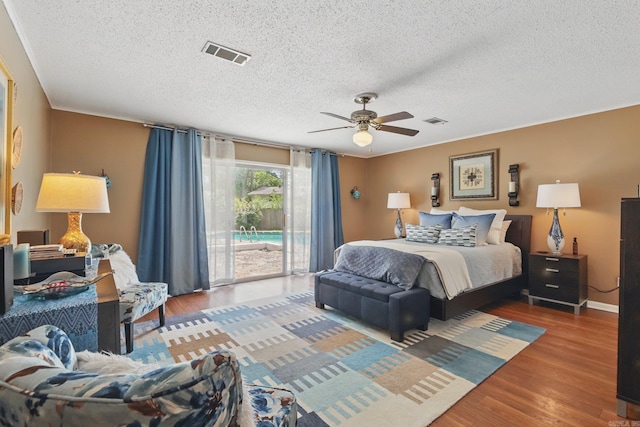 717 Choctaw Cir, Little Rock, AR 72205 - bedroom featuring access to outside, a textured ceiling, wood finished floors, and ceiling fan