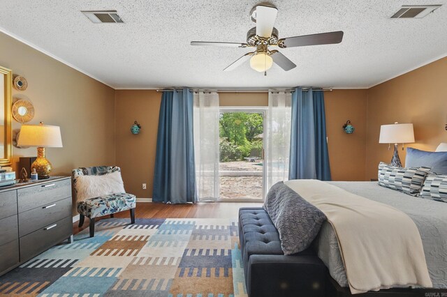 717 Choctaw Cir, Little Rock, AR 72205 - bedroom with access to outside, wood finished floors, a textured ceiling, a ceiling fan, and ornamental molding
