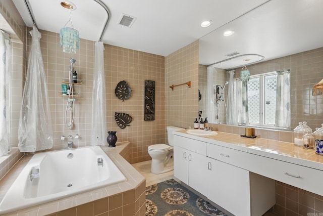 717 Choctaw Cir, Little Rock, AR 72205 - full bathroom featuring tile walls, toilet, tiled shower / bath combo, vanity, and recessed lighting
