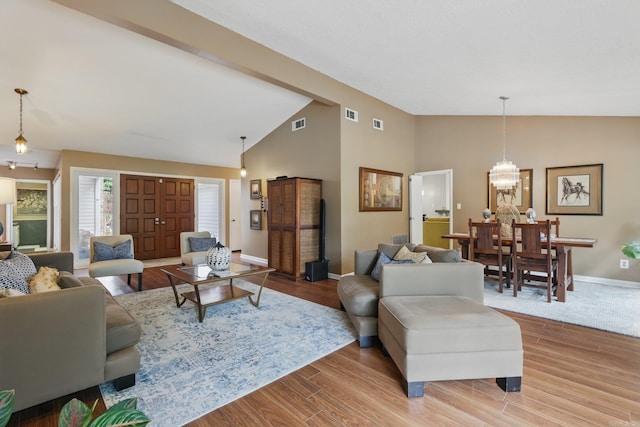 717 Choctaw Cir, Little Rock, AR 72205 - living room with baseboards, a chandelier, wood finished floors, and high vaulted ceiling