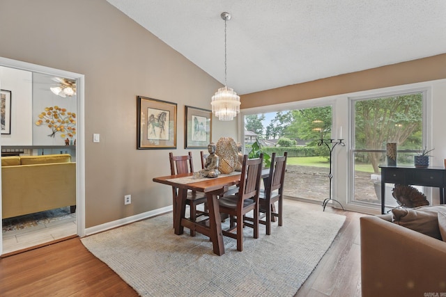717 Choctaw Cir, Little Rock, AR 72205 - dining area with a chandelier, wood finished floors, baseboards, and high vaulted ceiling