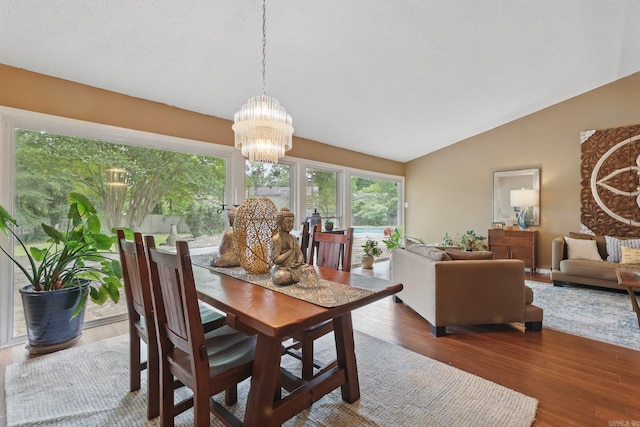 717 Choctaw Cir, Little Rock, AR 72205 - dining room with vaulted ceiling, wood finished floors, and a chandelier
