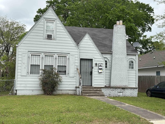 view of front facade featuring a chimney, entry steps, cooling unit, and roof with shingles