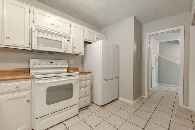 200 Pine Frst Unit F3, Maumelle, AR 72113 - kitchen featuring white appliances, light tile patterned floors, light countertops, white cabinets, and a textured ceiling