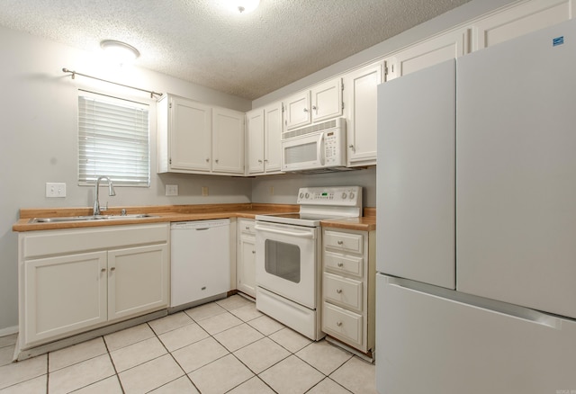 200 Pine Frst Unit F3, Maumelle, AR 72113 - kitchen featuring white appliances, a sink, a textured ceiling, white cabinets, and light tile patterned floors
